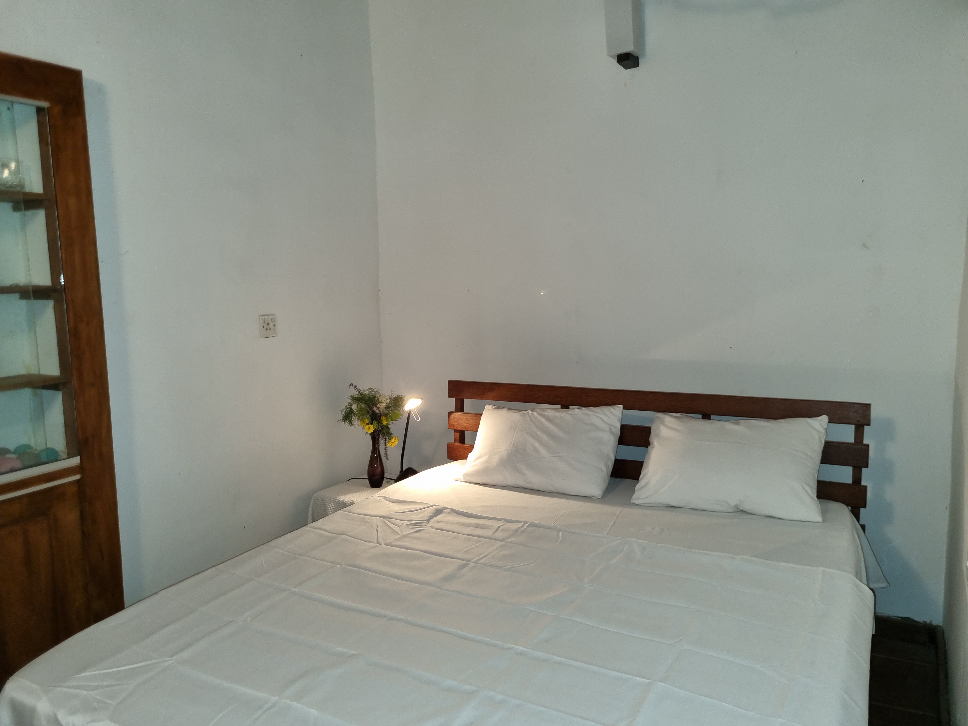 Double bedroom with garden view at Lion Shade Bungalow