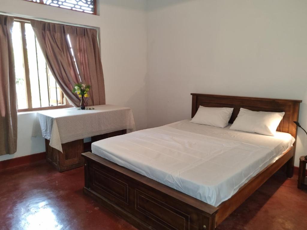 Queen-sized bedroom with natural light at Lion Shade Bungalow